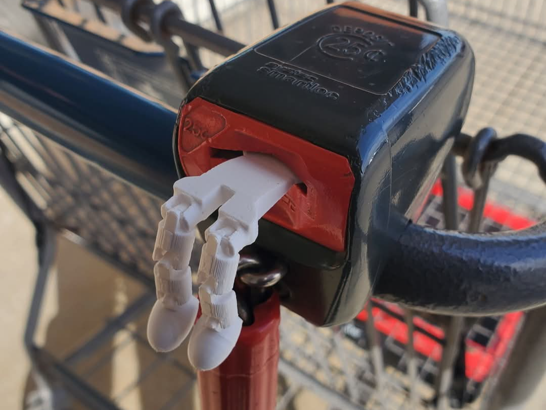 Vaciabolsillos impreso en 3D presentado desde un lado con compartimentos visibles y un fondo neutro