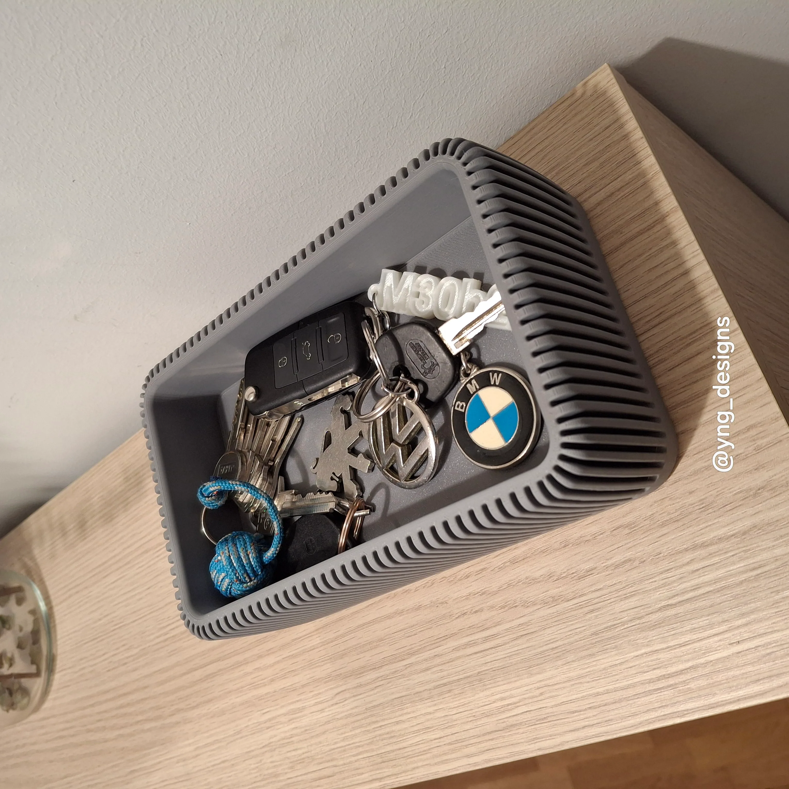 Vaciabolsillos impreso en 3D con compartimentos organizadores sobre una mesa clara